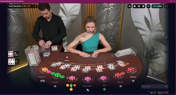 Live dealers setting up cards for blackjack game